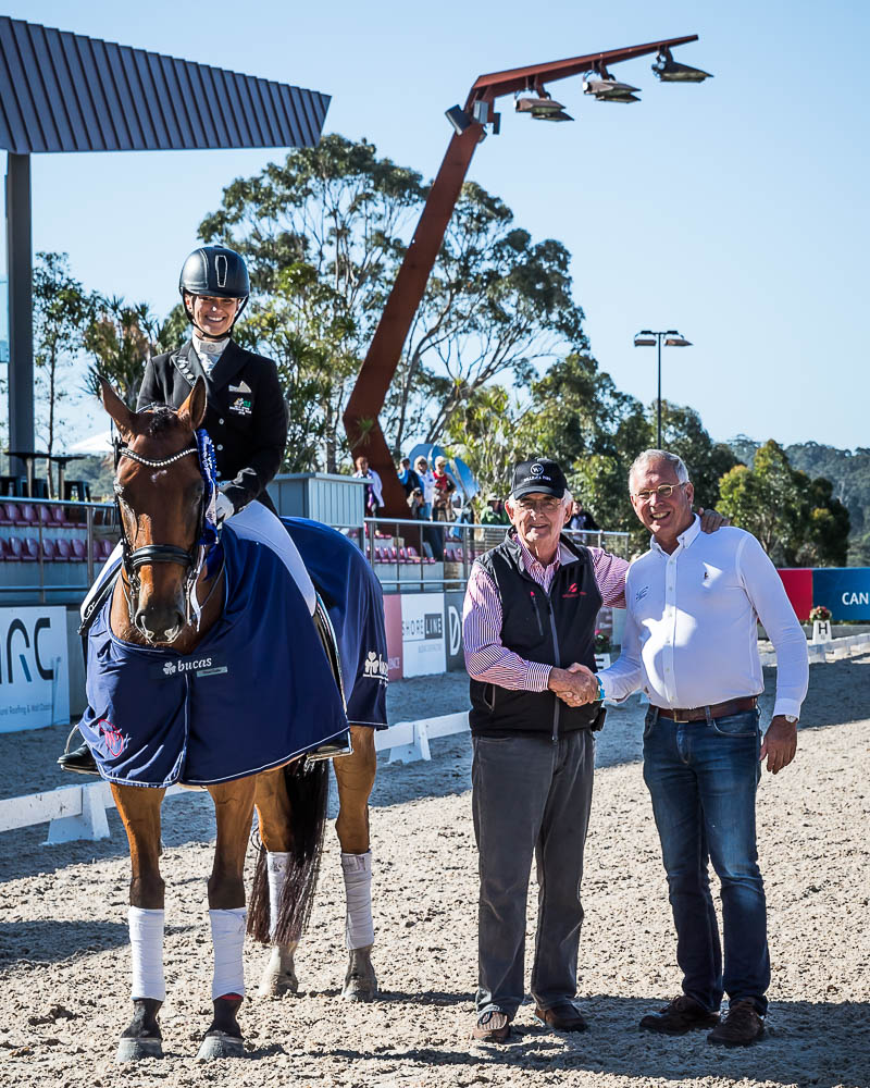 Terry Snow shaking hands with a man, standing next to a woman on a horse Terry Snow shaking hands with a man, standing next to a woman on a horse
